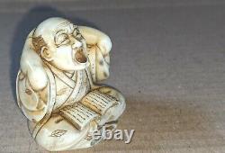 Meiji period Japanese fine carved Boxwood Netsuke of a yawning man reading